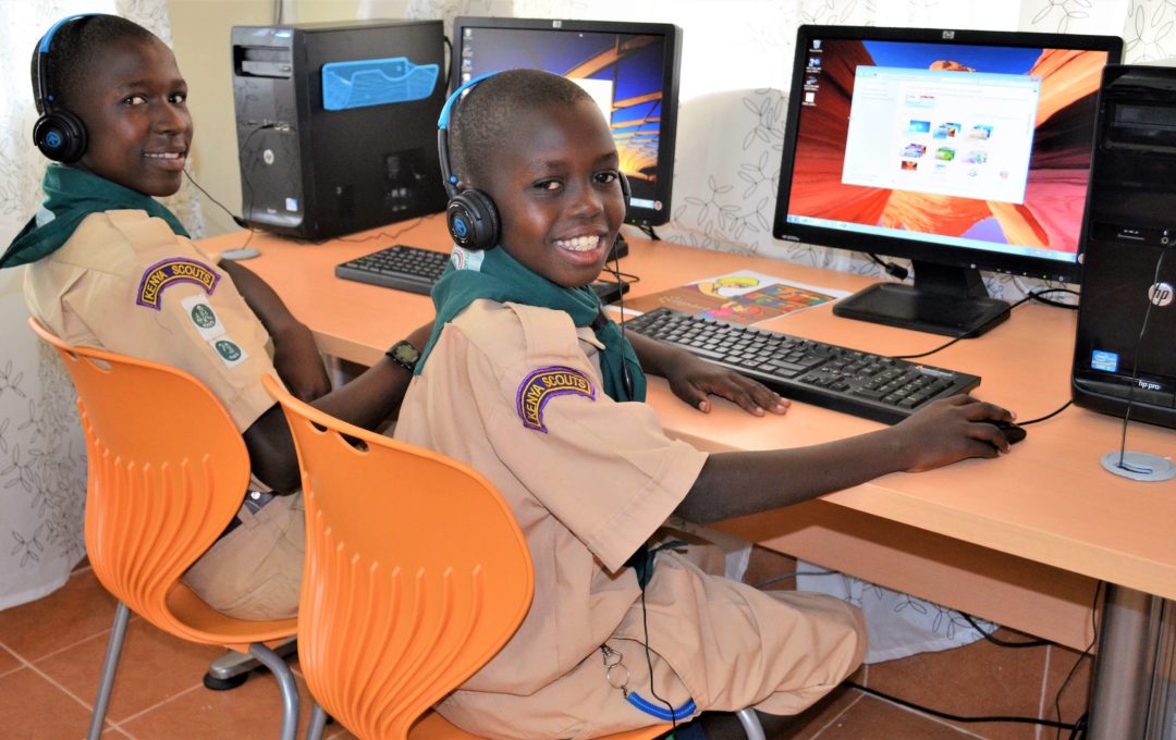 Scholars using the computer at the library