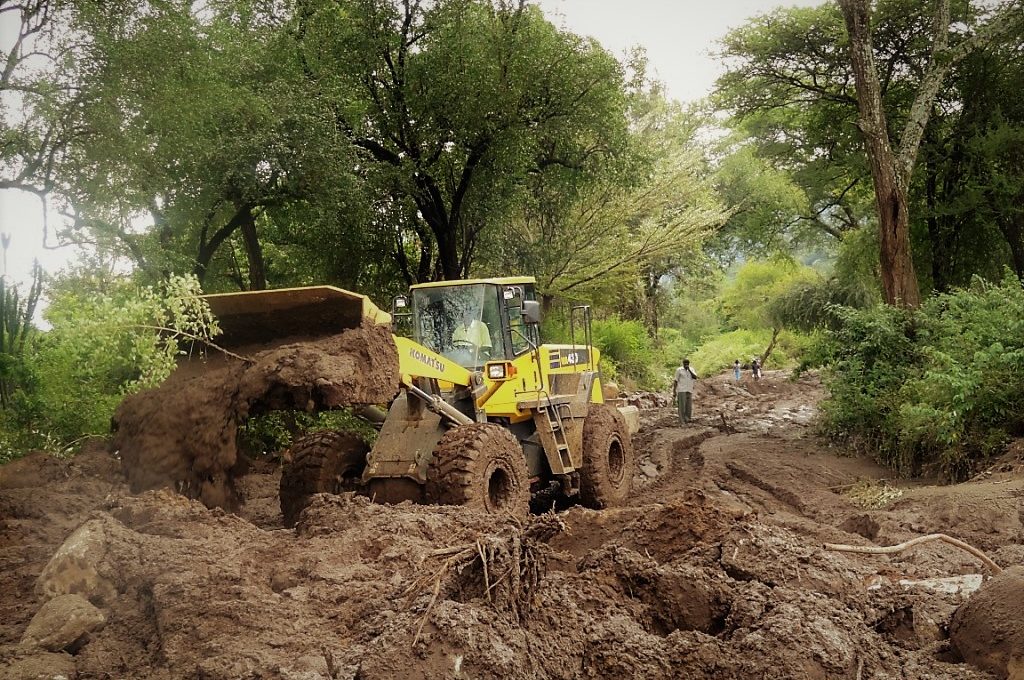 Yellow Komatsu tractor in the mud