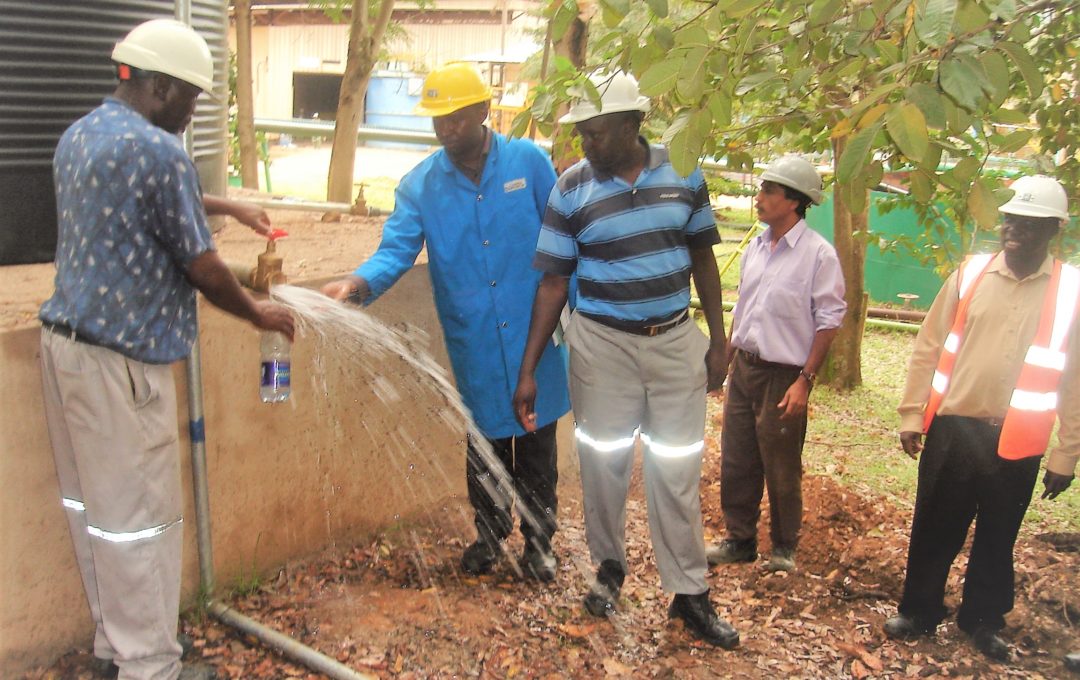 Workers trying the fresh water